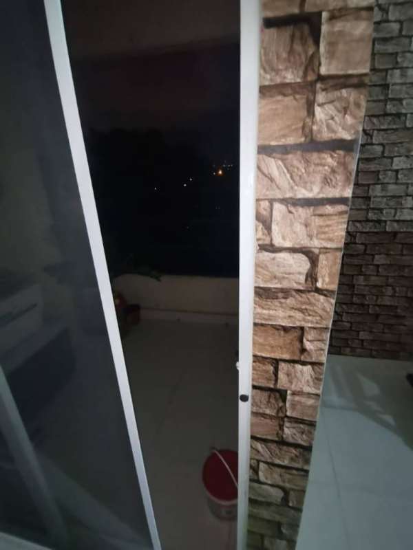 Balcony with stone veneer wall and night city view in Las Acacias, Juan Díaz, Panama City
