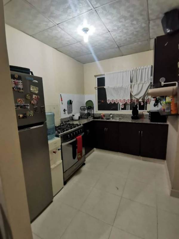 Kitchen with granite countertop, appliances and window in Las Acacias apartment Panama City