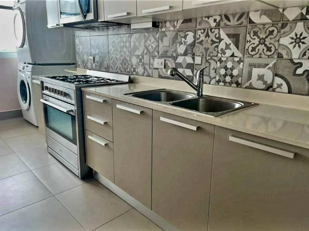 Laundry zone with stacked washer dryer, window, backsplash in Altamira Residences El Cangrejo