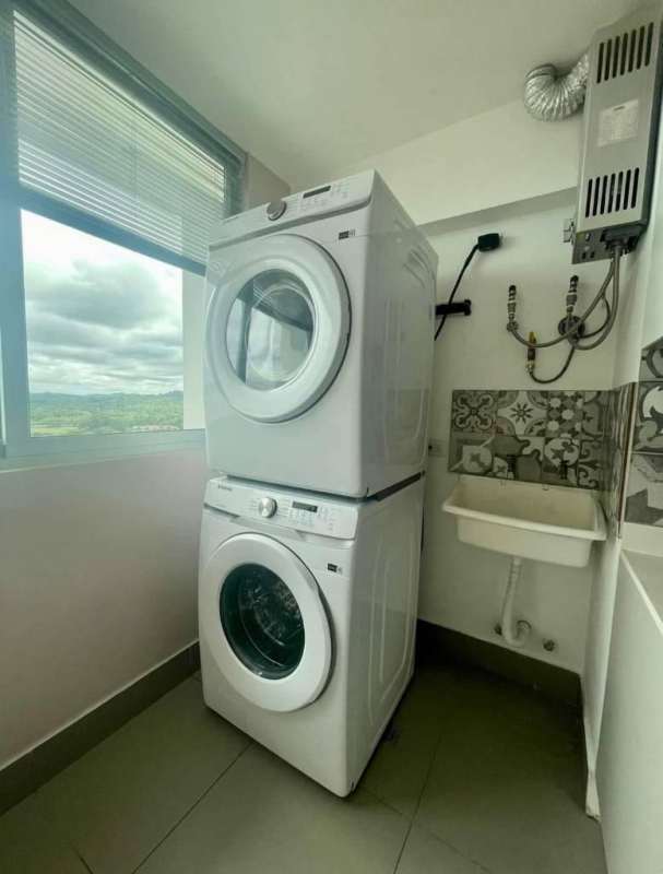 Bedroom featuring built-in closet, large window with city view in Altamira Residences Panama City