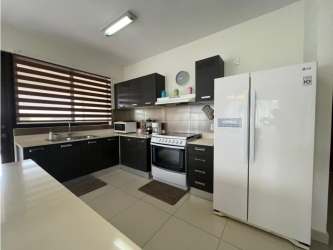 Bright open plan living dining and kitchen with island in Panama Pacifico apartment