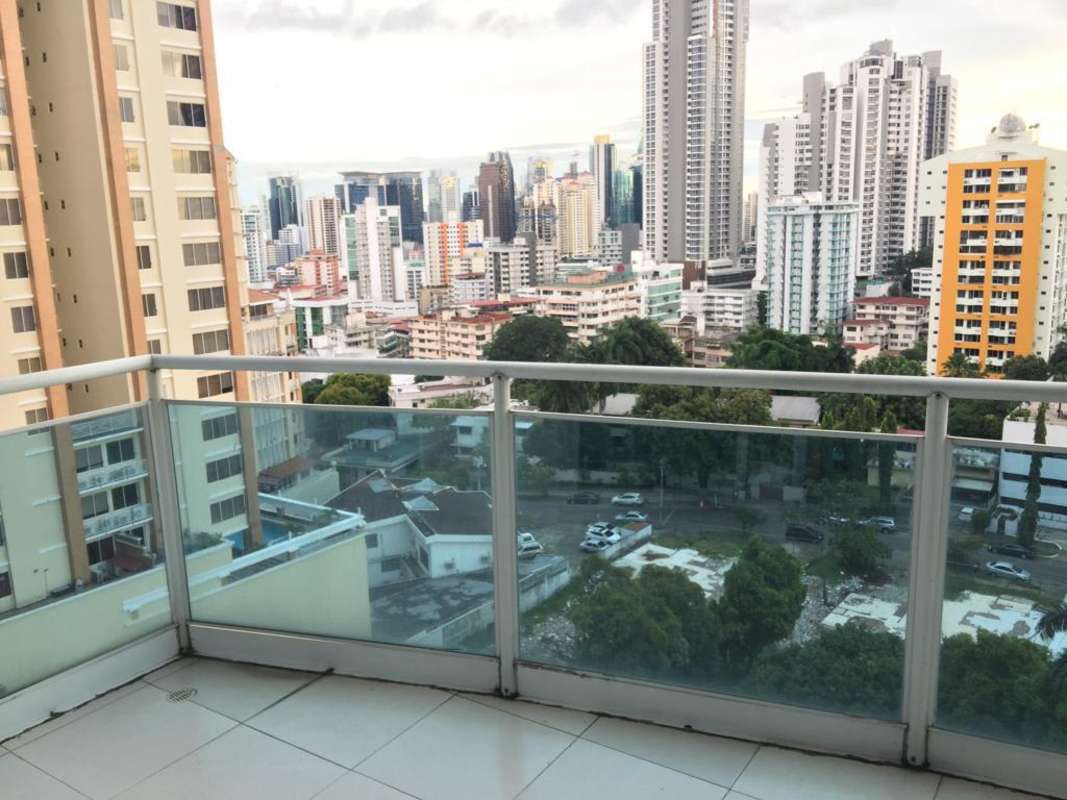 Bright living area with wall-to-wall sliding glass doors leading to balcony in PH Mont Royale Panama