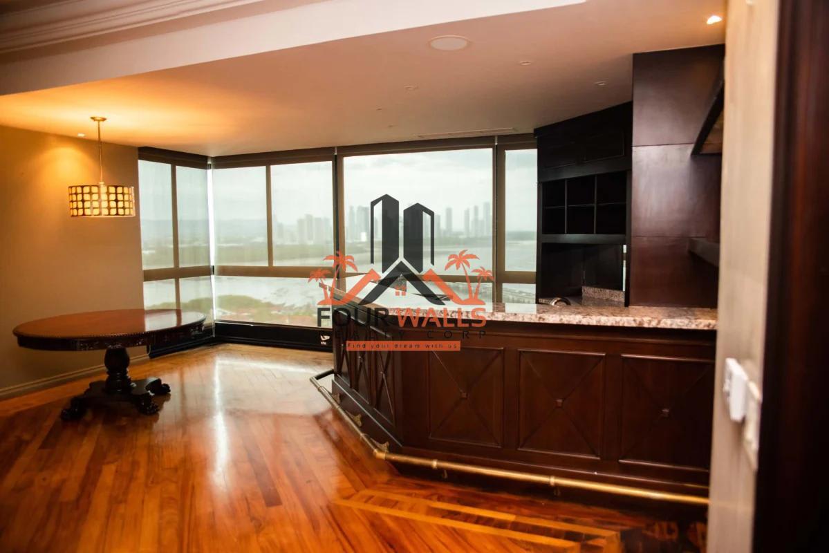 Luxury living room with bay windows overlooking ocean in PH Panamar penthouse Panama