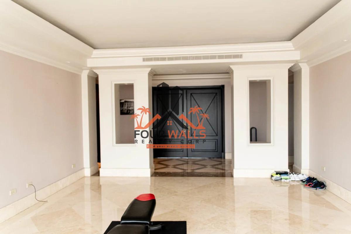 Spacious walk-in closet with built-in shelves island bench in PH Panamar penthouse Panama