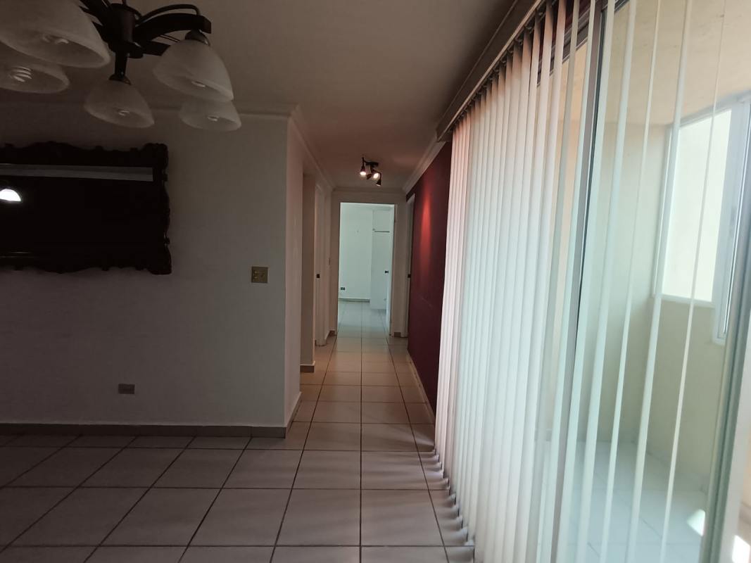 Hallway with tiled floors, mirror, red accent, vertical blinds PH Mikonos Panama City