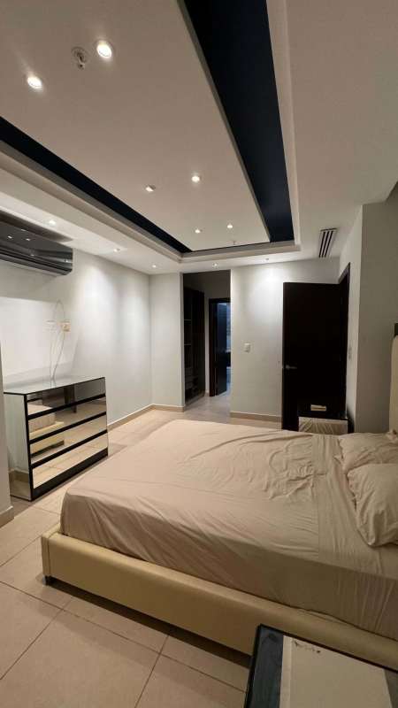 Elegant bedroom featuring floor-to-ceiling windows with ocean and skyline views in BICSA tower