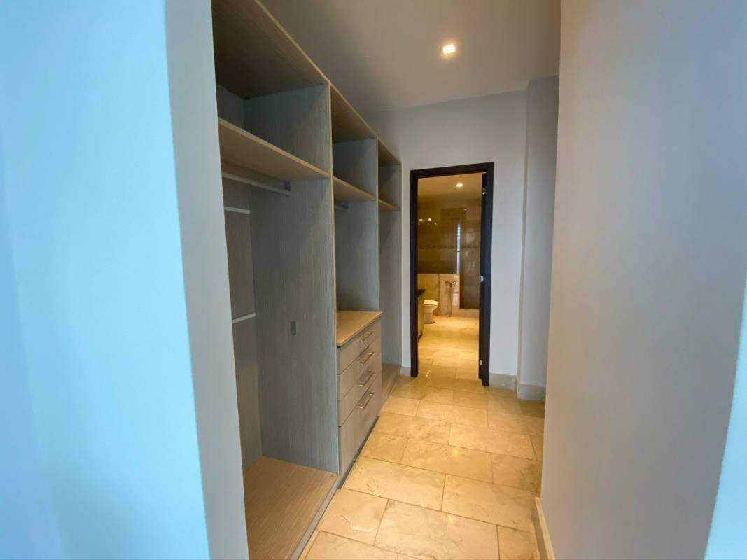 Modern living-dining area with floor-to-ceiling windows and sea views at Punta Pacífica condo