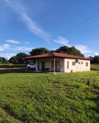 Minimalist modern kitchen with wood table and appliances in Pedasí Oasis Panama
