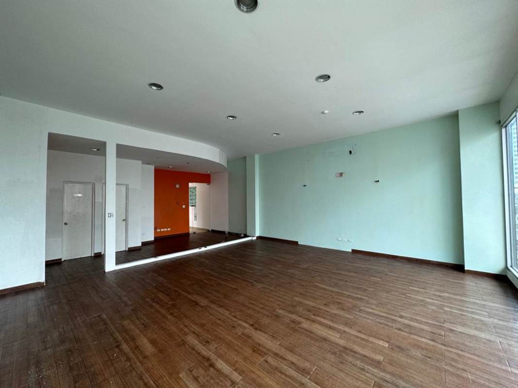 Large open plan commercial retail space with accent walls and wooden flooring in San Francisco Panama