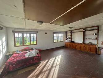 Spacious rustic bedroom with natural light tiled floor in Volcán Panama