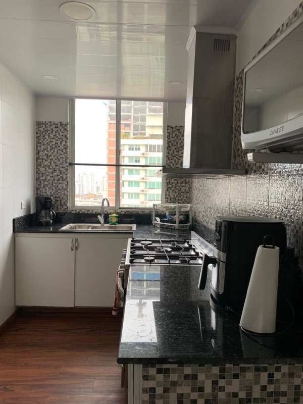 Modern apartment kitchen with granite counters, stainless appliances and large window PH El Cangrejo Plaza Panama