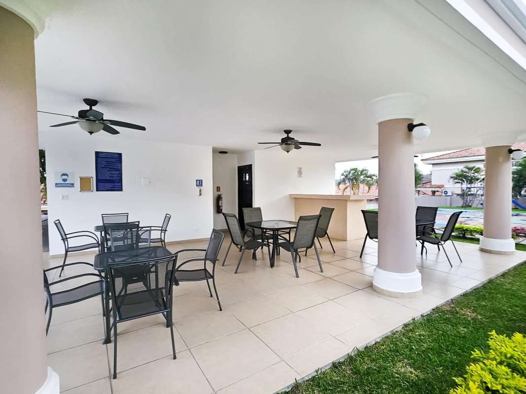 Spacious bedroom with windows and leather sofa in Altos del Country house Panama