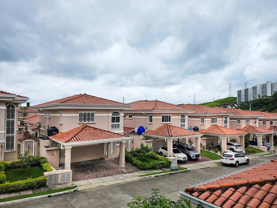 Red tile roof houses and garden in Altos del Country in Condado del Rey Panama