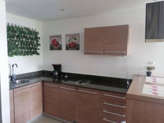 Modern studio kitchenette with granite countertop and overhead cabinets at Playa Blanca