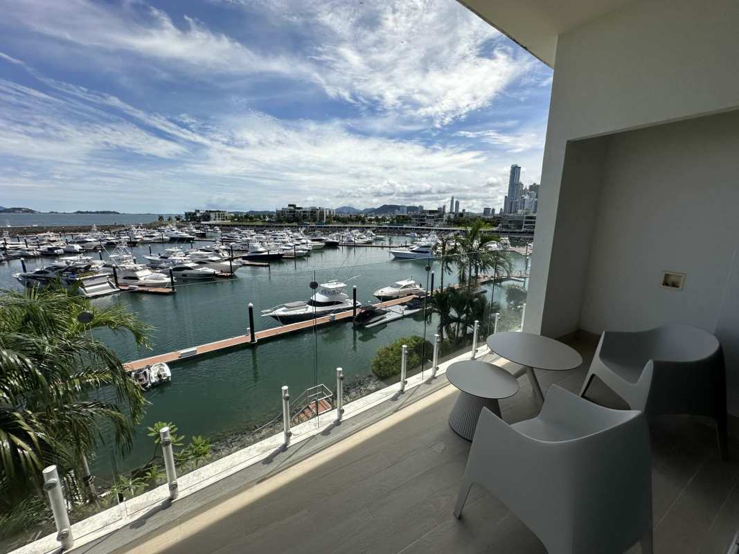 Luxury master bedroom with marina view, wood floors, floor-to-ceiling glass in Ocean Reef Panama condo