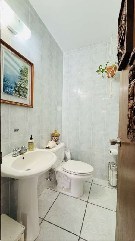 Small bathroom with pedestal sink, modern tiles and fixtures in PH Torre Altamira Panama