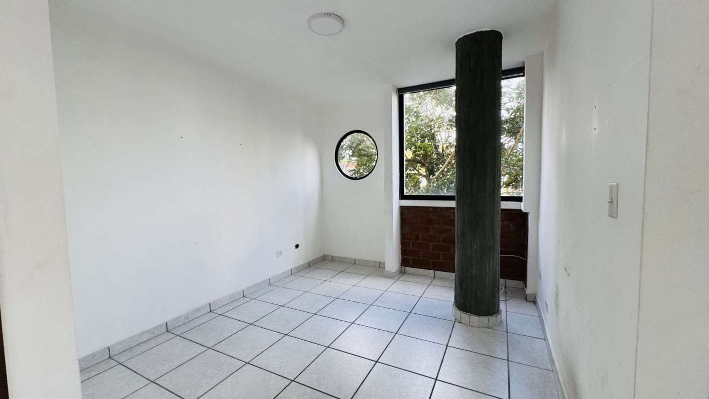 Kitchen with white and wood cabinetry, appliances and granite look countertops at PH Torre Altamira