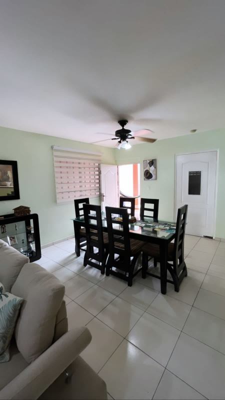 Fenced backyard with green lawn, trampoline, kids play area and covered patio in Villa Zaita home Panama