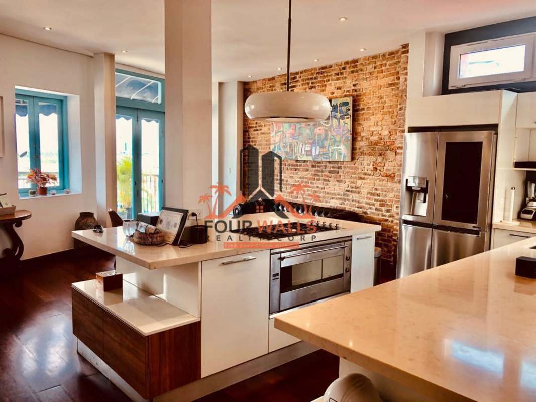Spacious open-plan living-dining area brick wall PH Jerónimo Casco Viejo