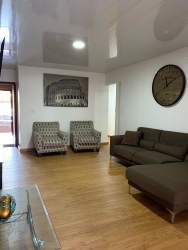 Living room with sectional sofa, wood flooring, modern decor at La Arboleda La Chorrera Panama