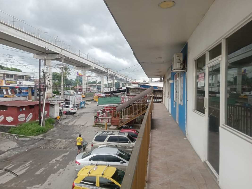 Parking lot with walkway beside commercial shopping plaza near Pan-American Highway in 24 de Diciembre Panama City