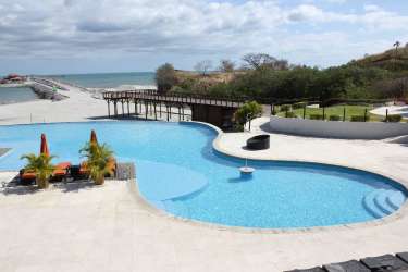 Vacant grassy land ocean view palm trees sky Vista Mar Panama Beach Resort