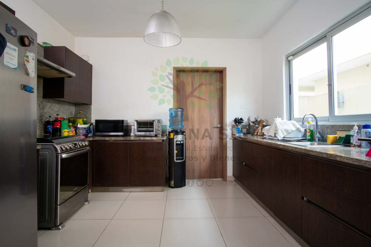 Bright kitchen with granite counters and window in PH Altos del Parque San Miguelito