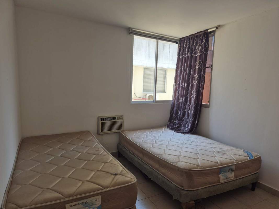 Bedroom with tile floor window split air unit PH Avenida Balboa Residences Panama City
