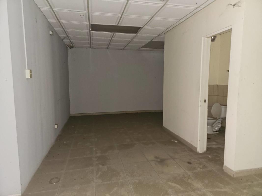 Dusty commercial room with large windows, suspended ceiling office space Pacora Panama