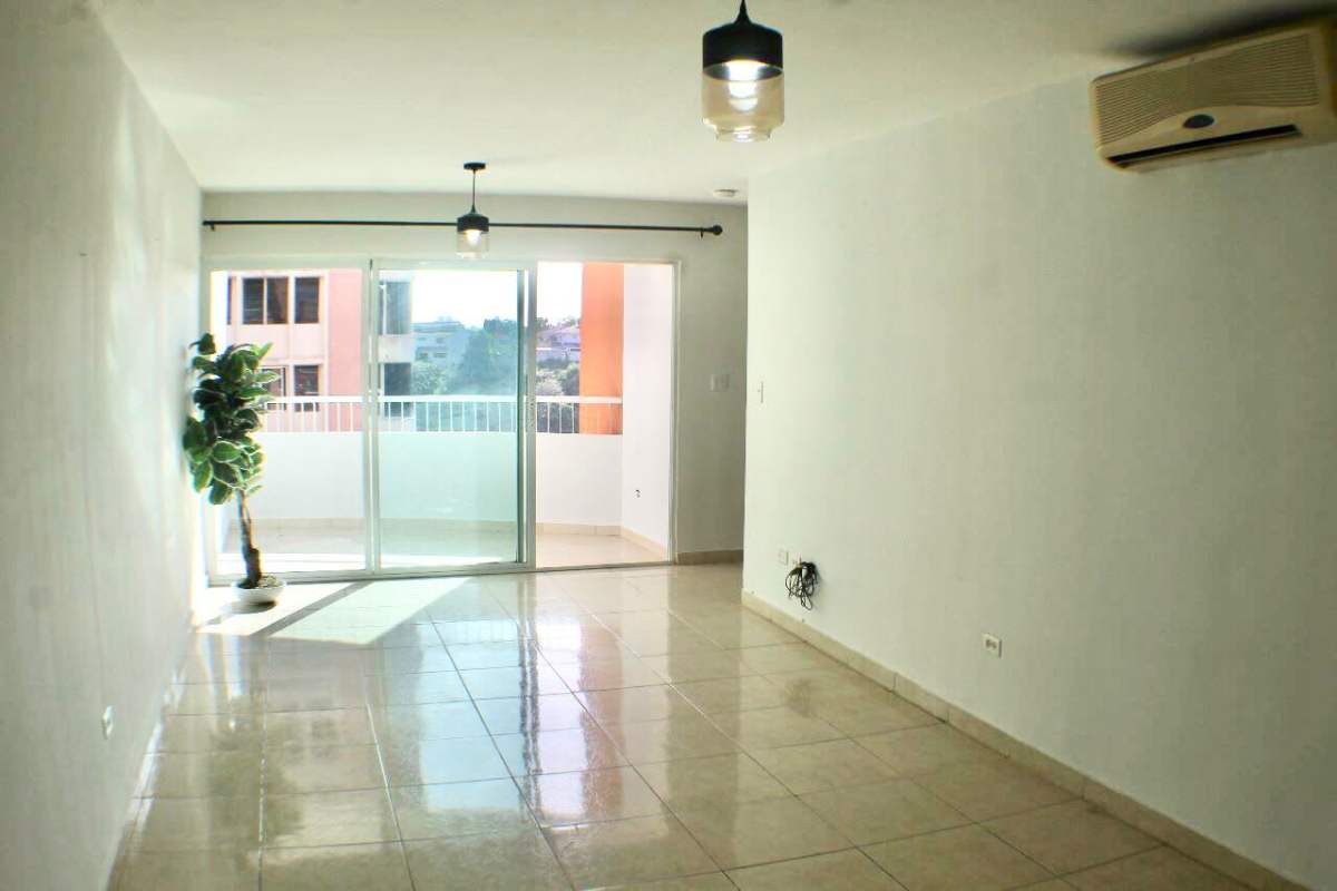 Living room with sliding doors to balcony tile floors AC unit PH Villa de las Fuentes Panama