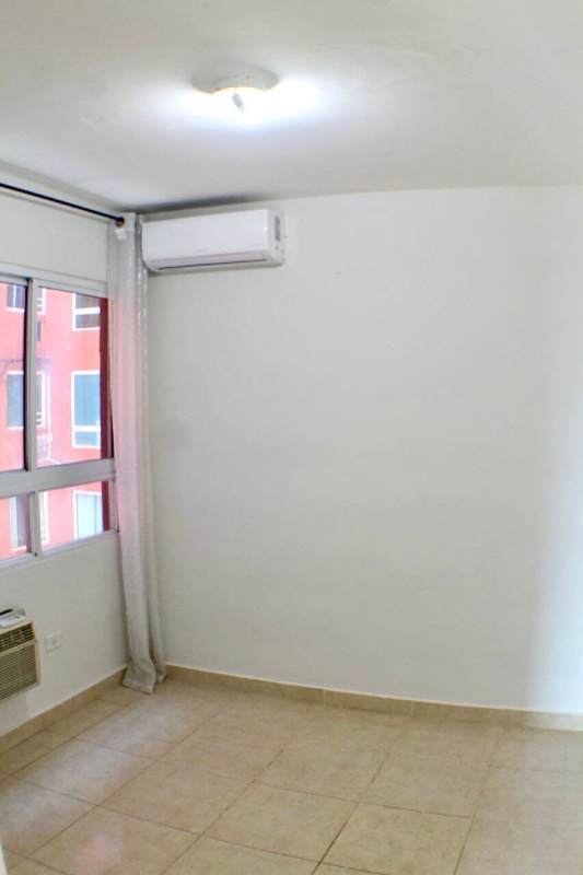 Bedroom space with split AC, tile flooring, bright window PH Villa de las Fuentes Panama