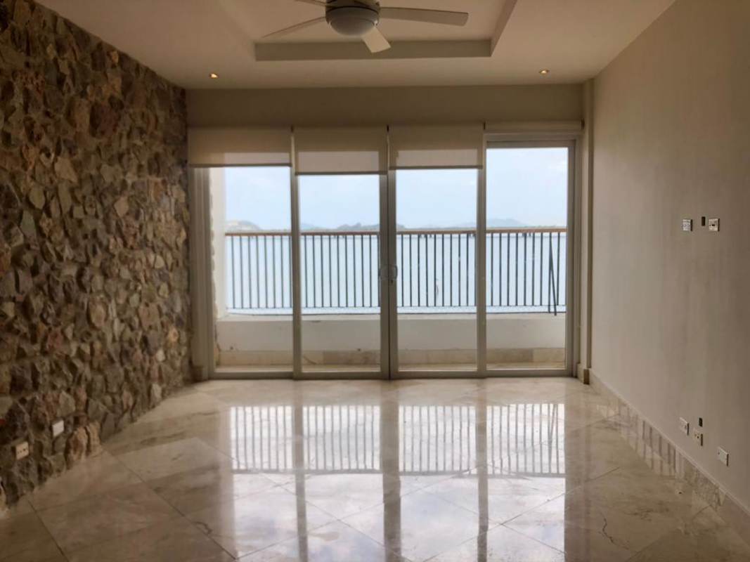 Living room with stone accent wall and AC in Casco Viejo historic apartment