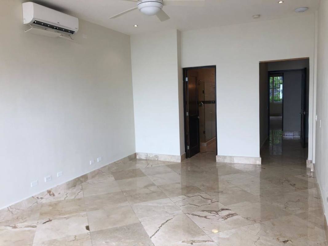 Bedroom with marble floor, AC, ceiling fan and ensuite bath Casco Viejo Panama apartment