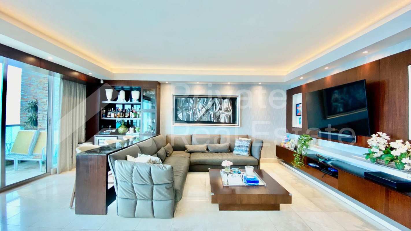 Bright open concept living and dining area with ocean view windows in Costa del Este luxury apartment