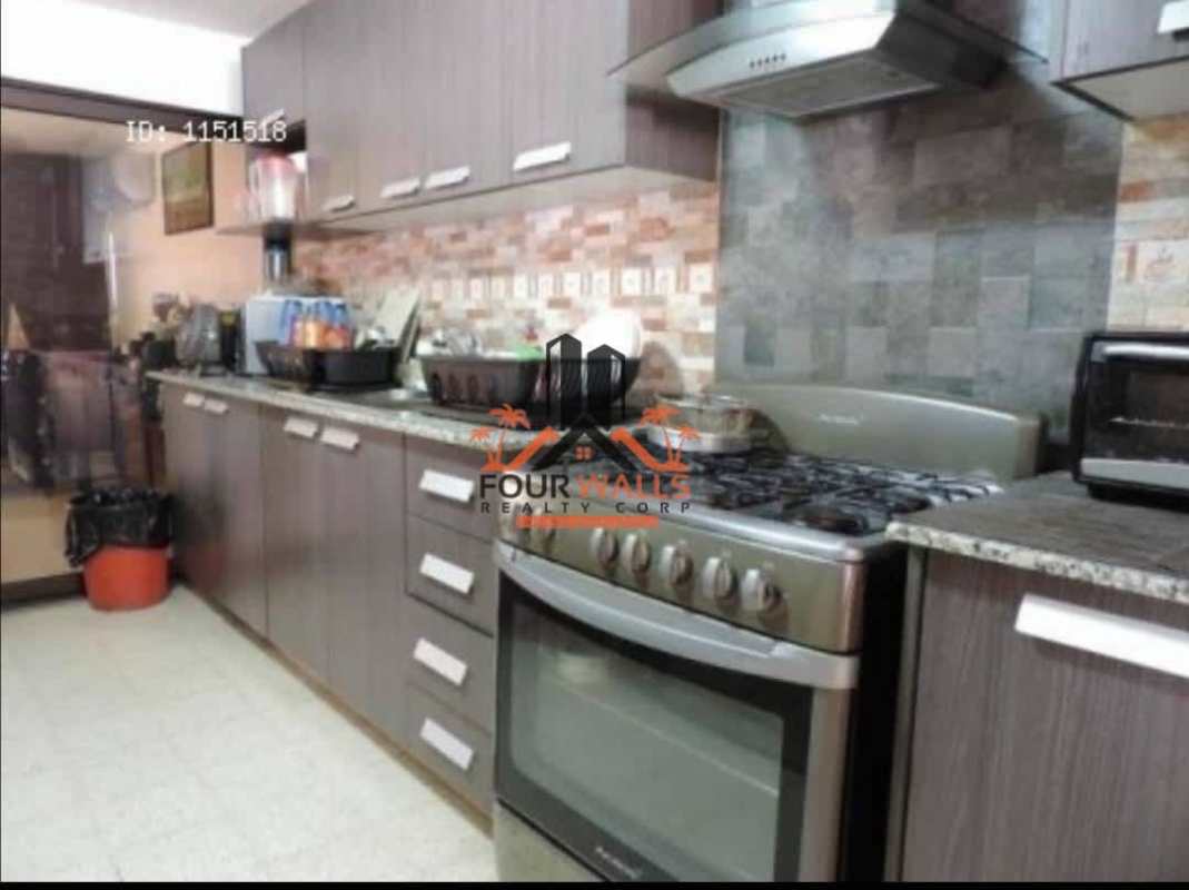 Contemporary kitchen features granite countertop, stainless steel appliances and ample storage in Betania Panama house