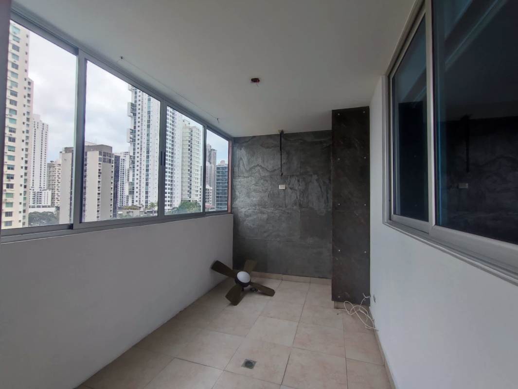 Large walk-in closet in dark wood cabinetry leading to master bathroom in PH Harmony Panama