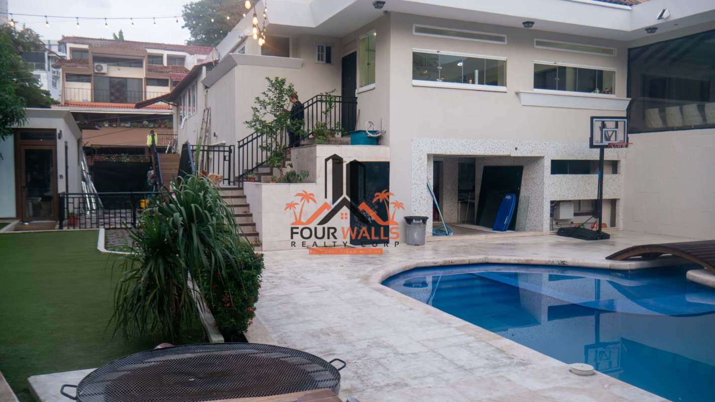 Spacious gourmet kitchen with island, marble accent wall, built-in appliances in Dos Mares Panama