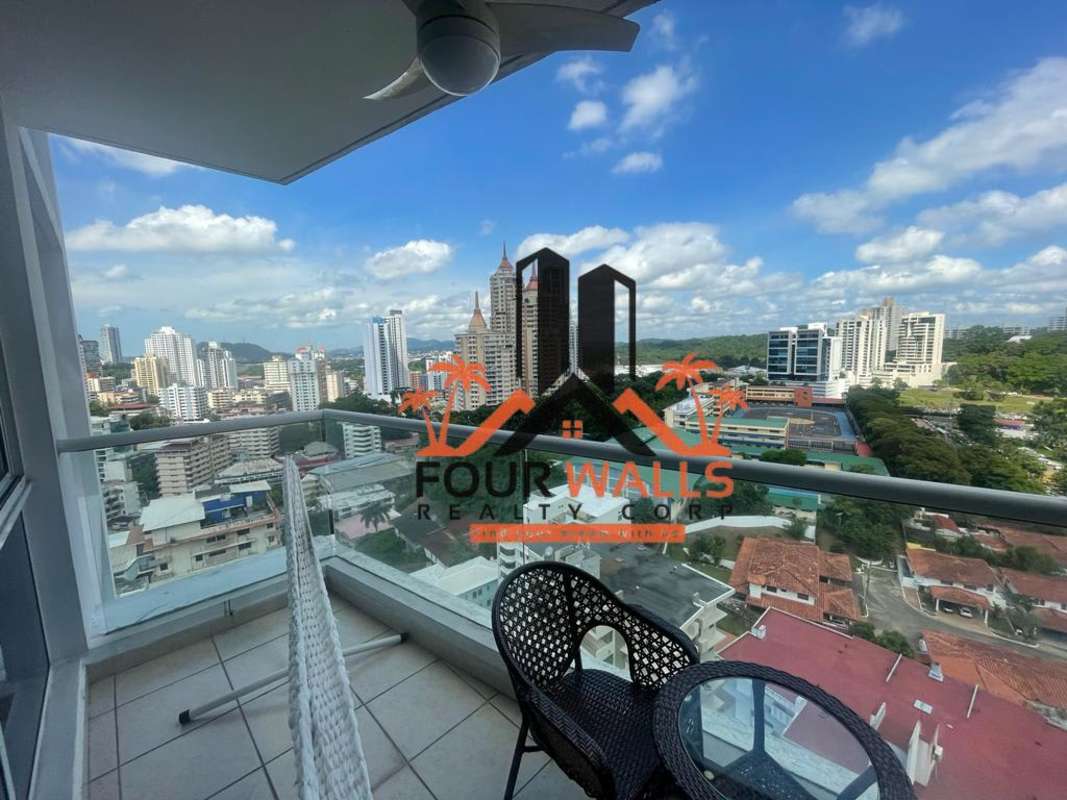 Furnished balcony with glass railings in PH Forum, enjoying urban skyline views