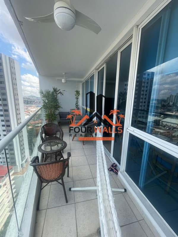 Modern gym with equipment, large windows and city views at PH Forum Panama