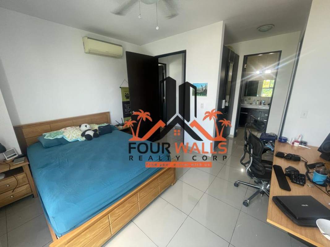 Bedroom with integrated desk workspace, ensuite bathroom and window light at PH Forum Panama