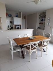 Open dining space next to modern kitchen with ocean view terrace in Bijao Quarry Heights Panama