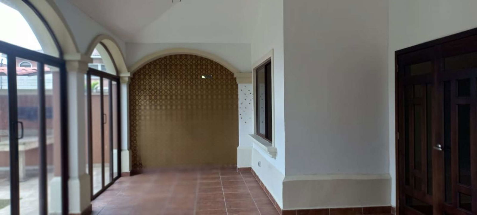 Bright open space living dining room with large windows tile floor Sunset Coast house Costa Sur Panama