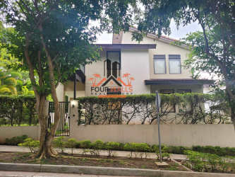 Fenced backyard with lawn and terrace in PH Nativa Panama Pacifico house