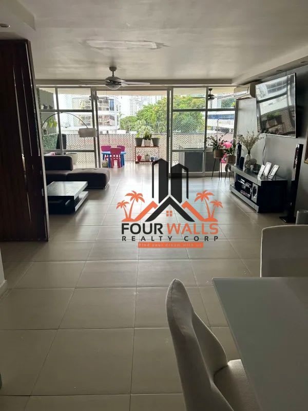 Modern living room with large windows, TV, balcony PH Diplomático Panama