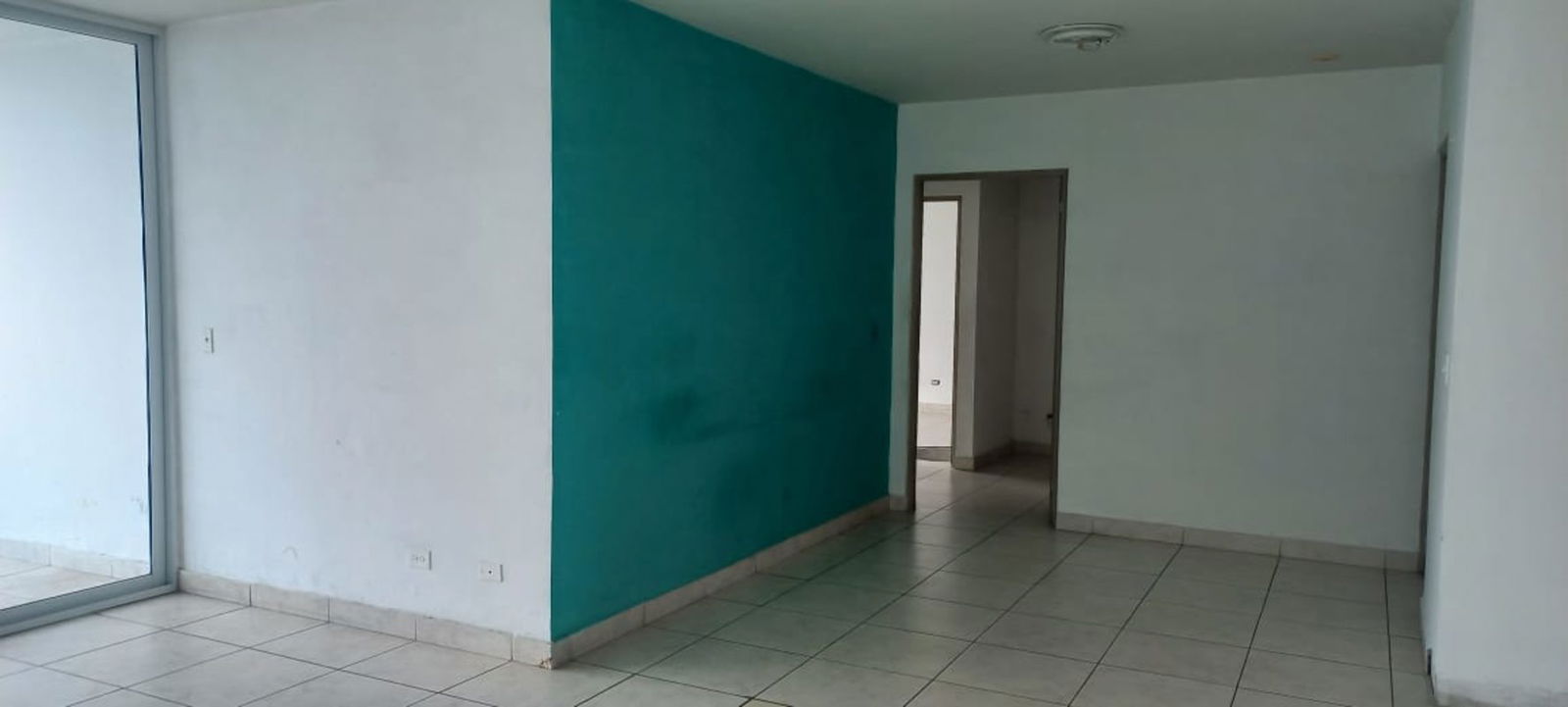 Bedroom with large window offering skyline views in PH Lexington Tower Betania Panama City