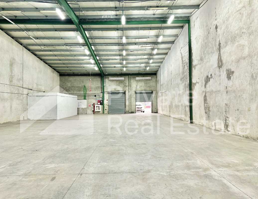 Industrial warehouse interior with concrete floors roller door and high ceilings