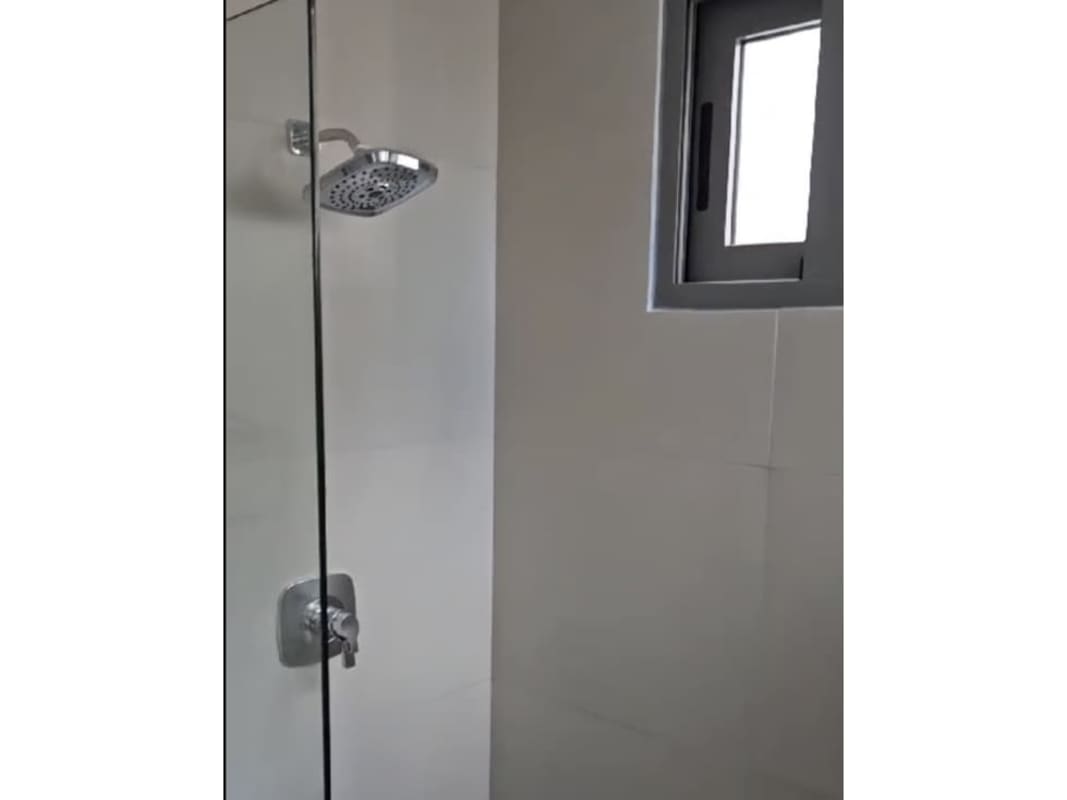 Luxury bathroom with rainfall shower and sliding window in Seapoint Panama