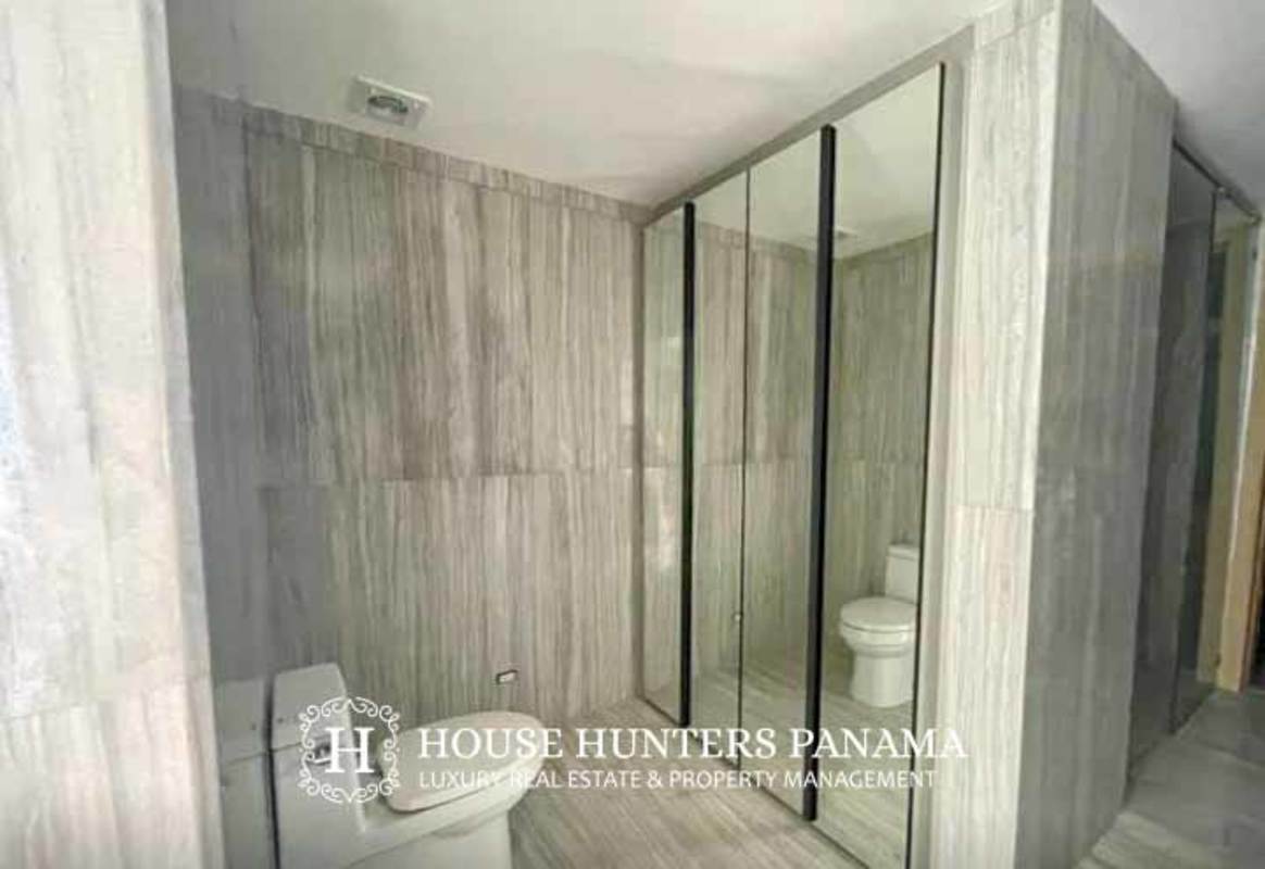 Modern living room with marble floors and panoramic golf course view in luxury Panama apartment