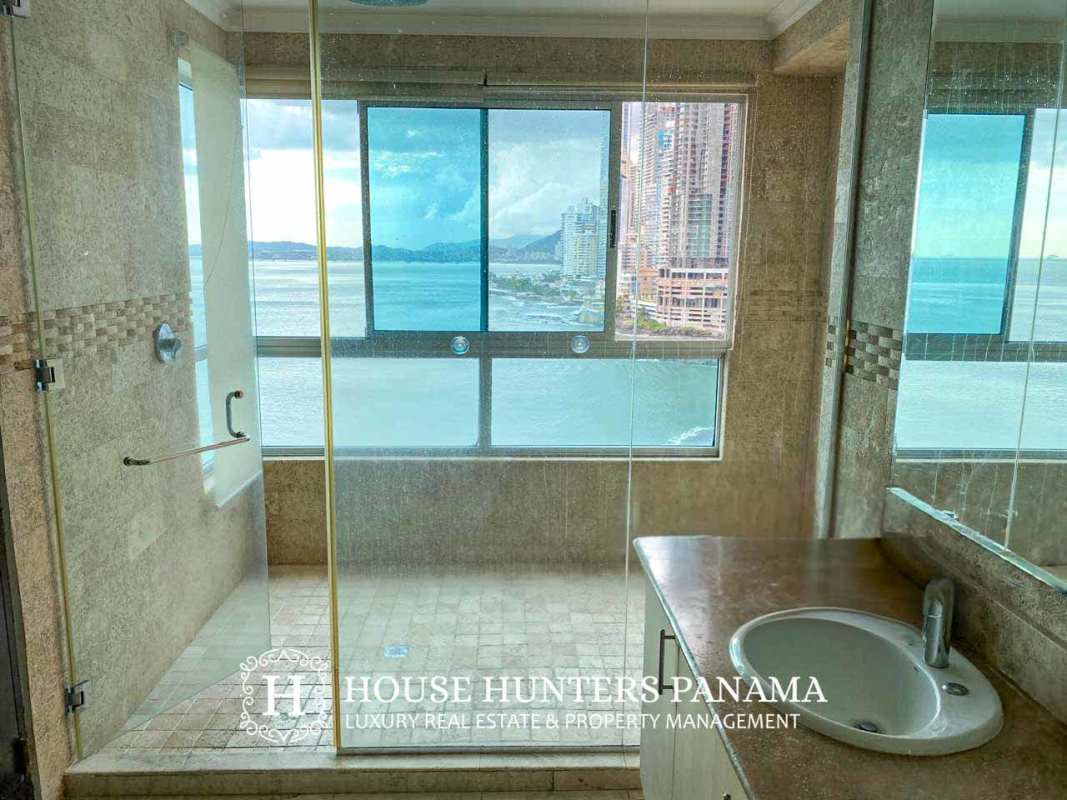 Bright secondary bedroom with floor-to-ceiling windows ocean skyline view in PH Aquamare Panama