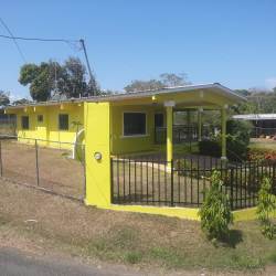 Yellow exterior single level house with gated fence and covered porch, Chitré Panama